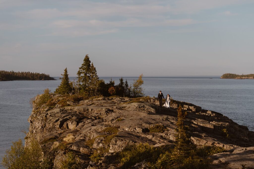 Bride and groom hiking away from their elopement ceremony site at Isle Royale National Park