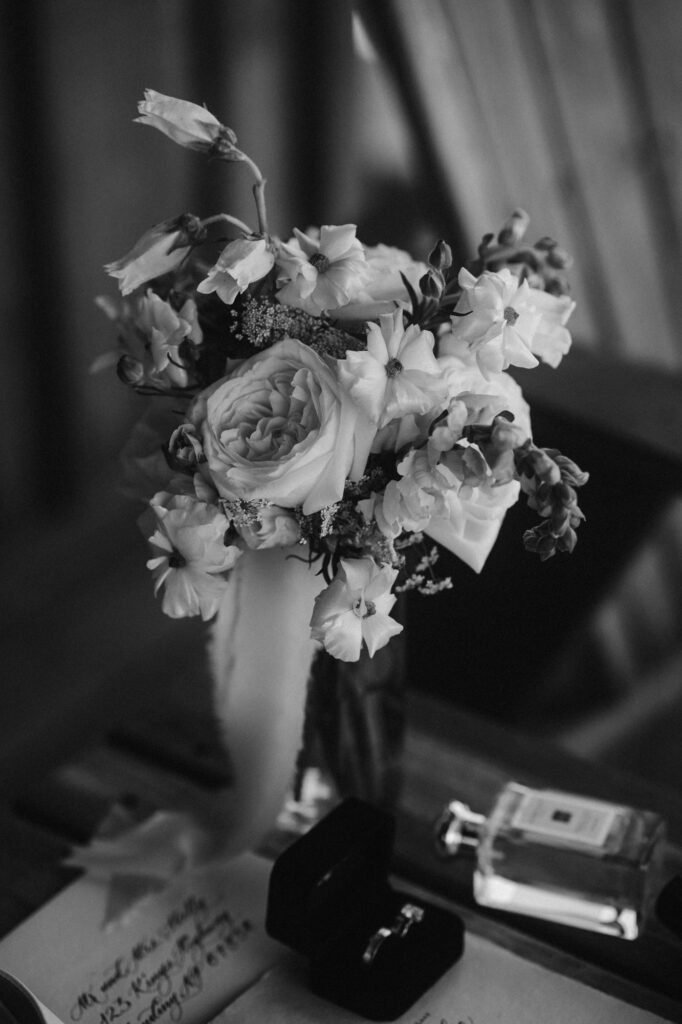 romantic black and white of wedding florals and perfume
