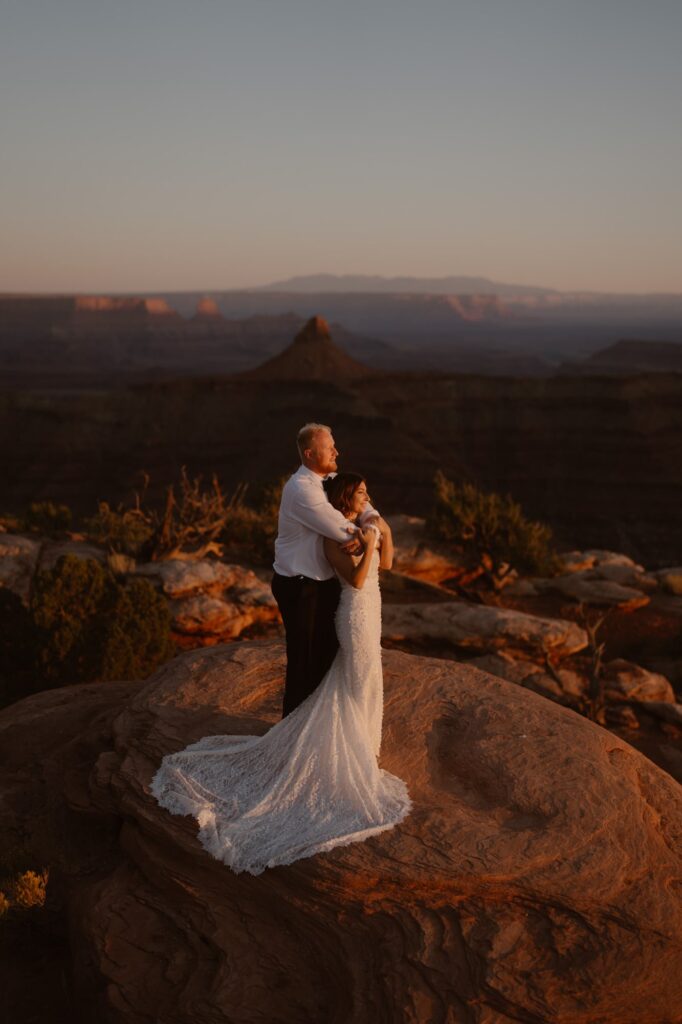 Cliffside sunset adventure elopement portraits in Moab, Utah