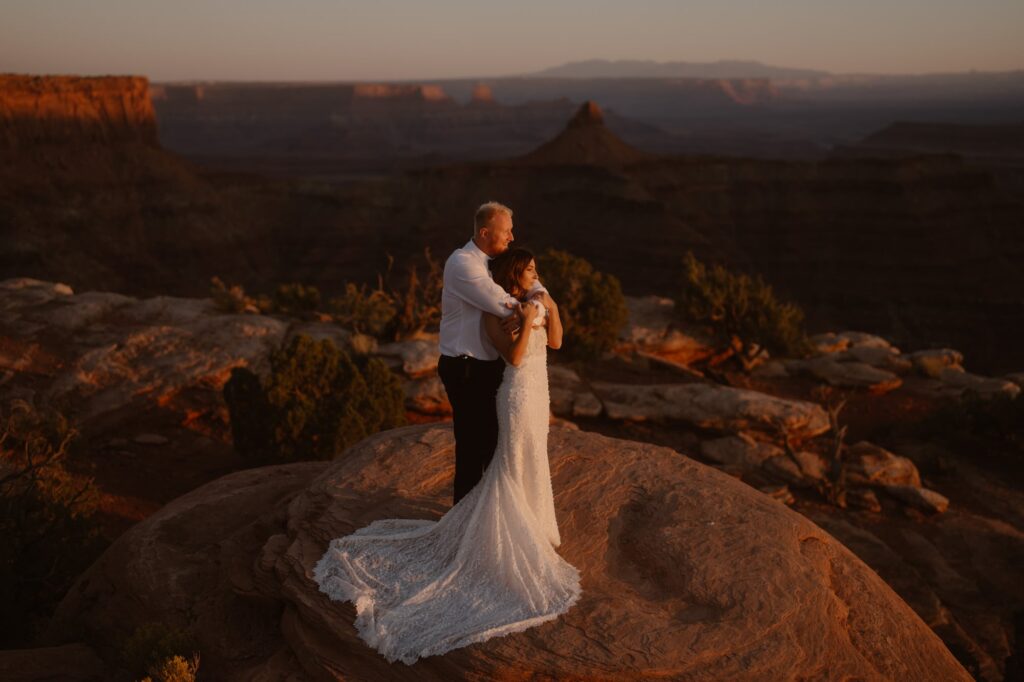 Glowing red sunset at adventure elopement in Moab, Utah