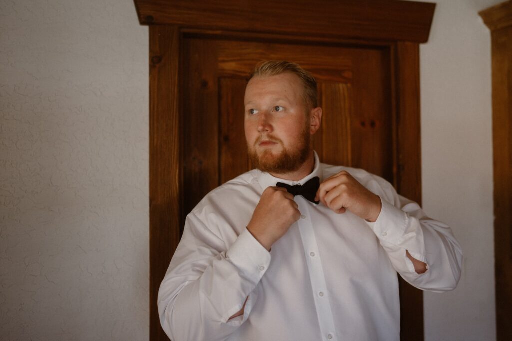 Groom getting ready for his Moab adventure elopement 