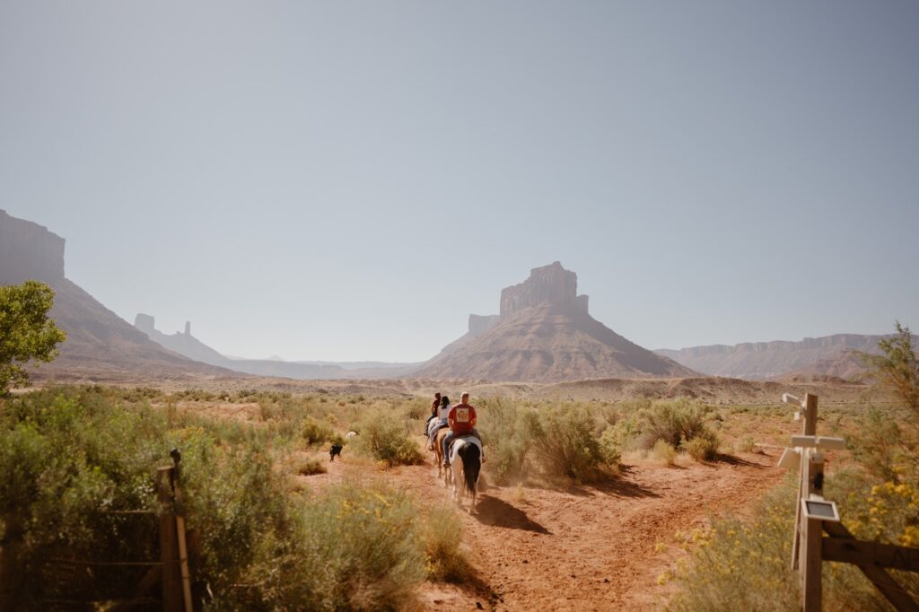 Horseback riding at couple's Moab adventure elopement