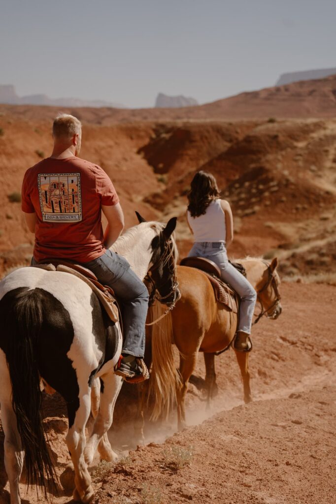 Couple on horseback during their elopement day in Moab, Utah