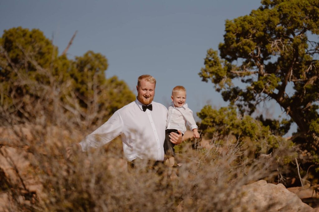 Groom and son excitedly walking to the elopement ceremony location