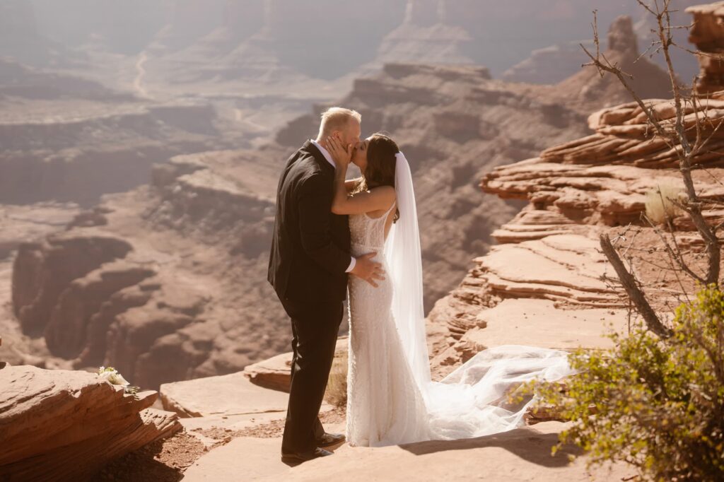 Couple sharing a first kiss at their Moab adventure elopement