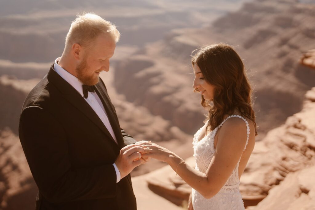 Couple exchanging rings at their Moab adventure elopement