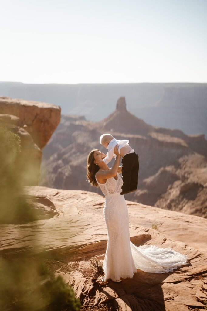Bride throwing her son in the air after her elopement ceremony