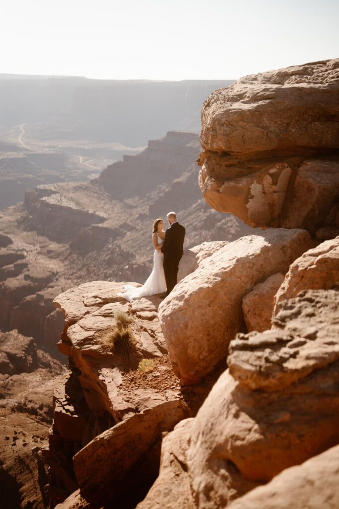 Couple standing on a cliff at Dead Horse Point State Park after their elopement