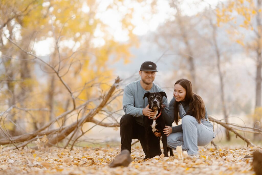 Couple snuggling with their dog during a portrait photography session