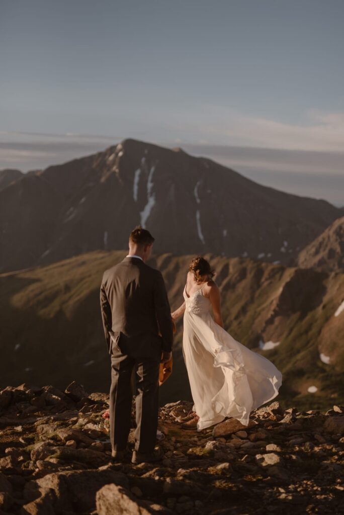 Bride and groom on a mountain top at sunrise in Colorado