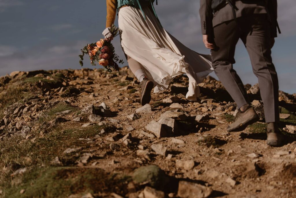 Bride and groom hiking on their wedding day in Colorado