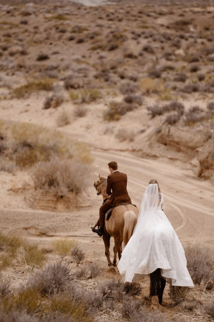 Bride and groom riding horseback at the Amangiri