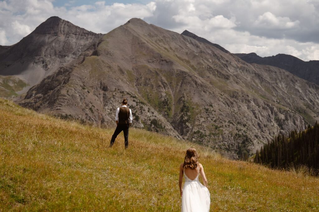 Amazing Colorado mountains and bride walking toward her groom