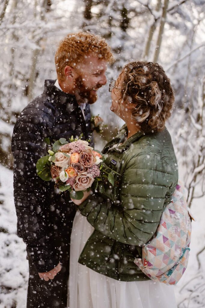 Couple with snow falling all around them
