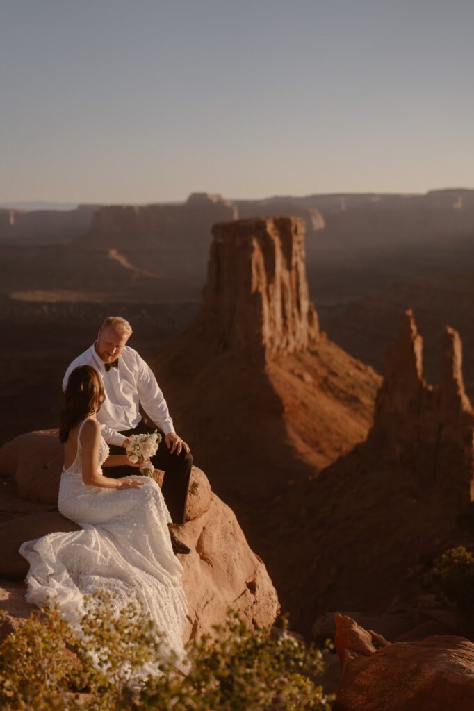 Couple on a cliff in Moab during their elopement