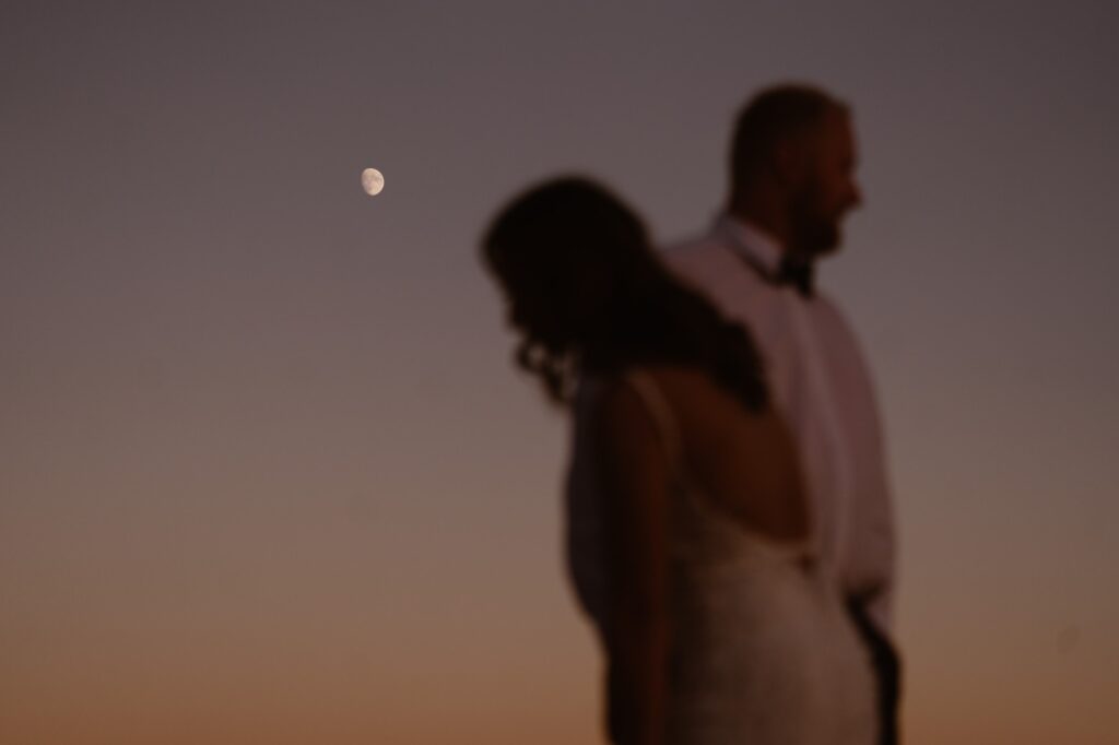 Sunset elopement portrait with the moon