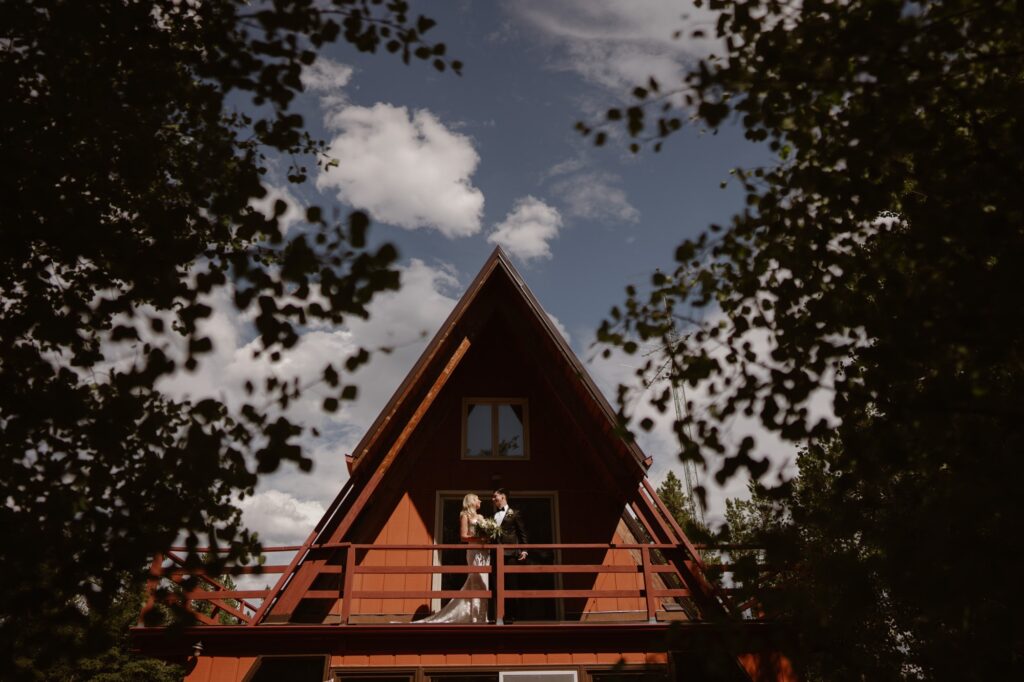 Bride and groom at their A-frame cabin during their elopement