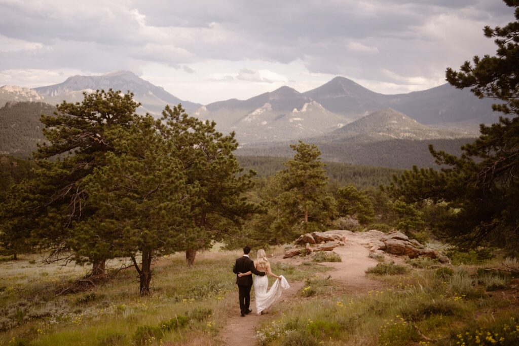 Couple walking down to 3M Curve on their elopement day in Rocky Mountain National Park