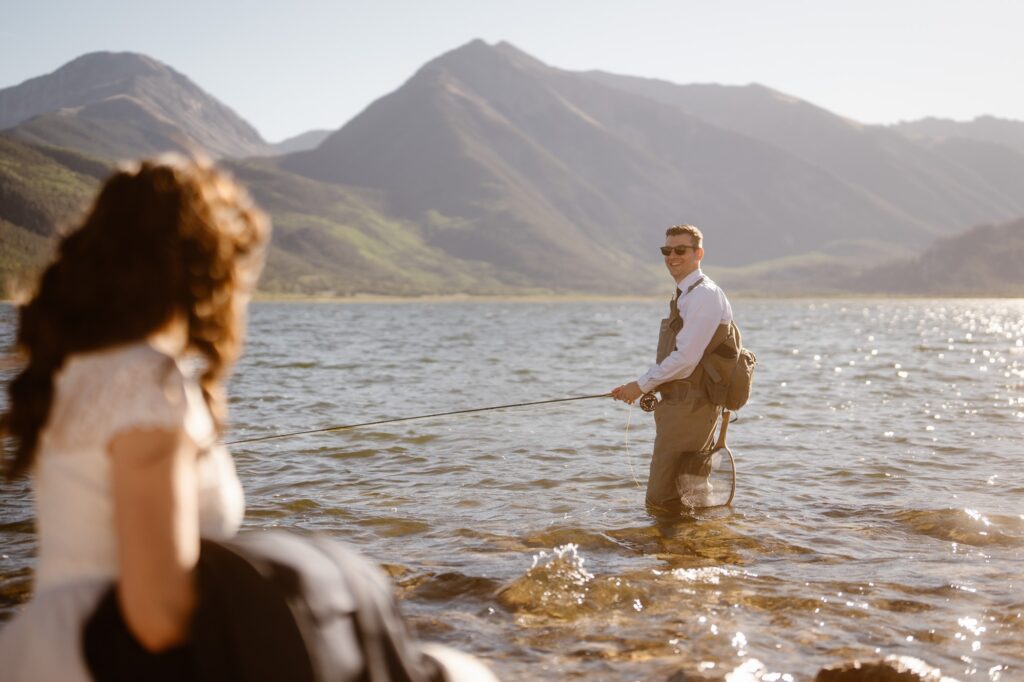 Bride and groom fly fishing in Colorado on their elopement day