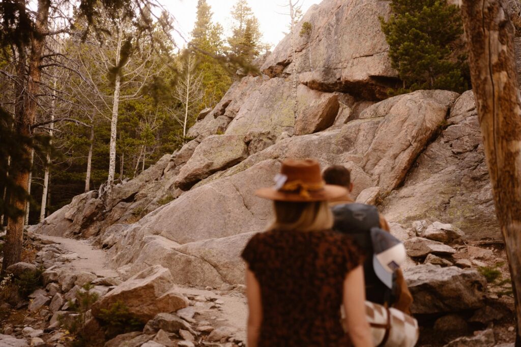 Couple hiking the trail to Dream Lake at their engagement session