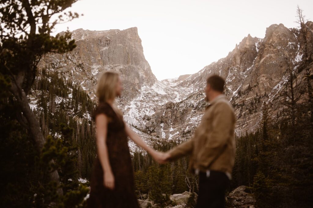 Couple looking off into the distance in the mountains