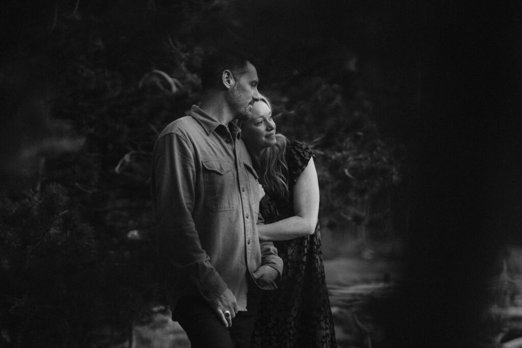 Romantic black and white image of couple looking off into the distance