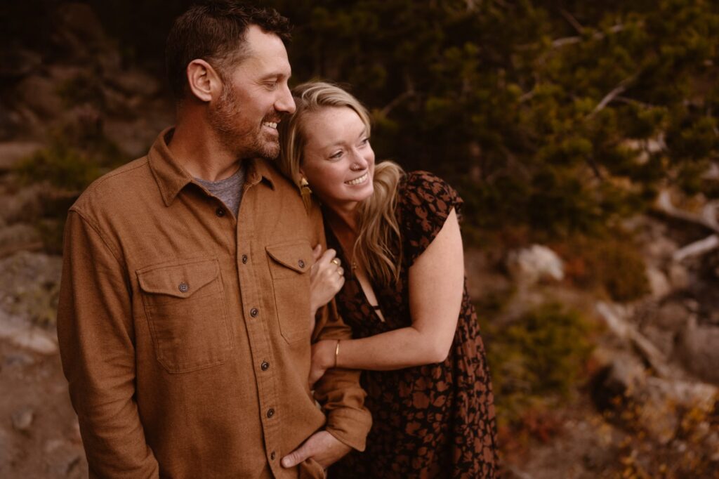 Couple snuggled up in the mountains during their engagement session