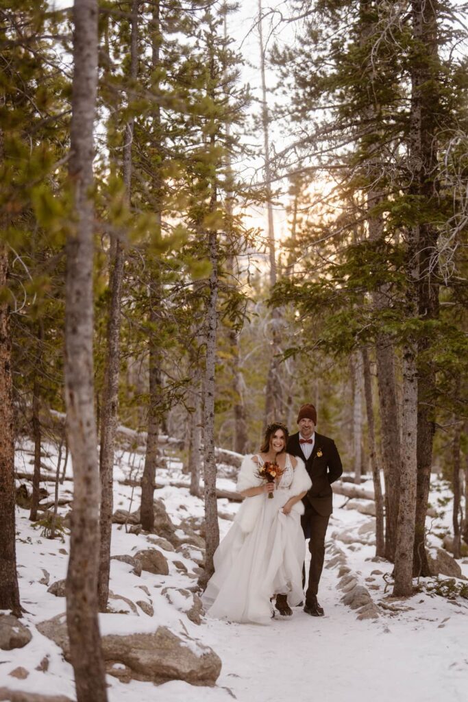 Bride and groom hiking to Dream Lake on their elopement day