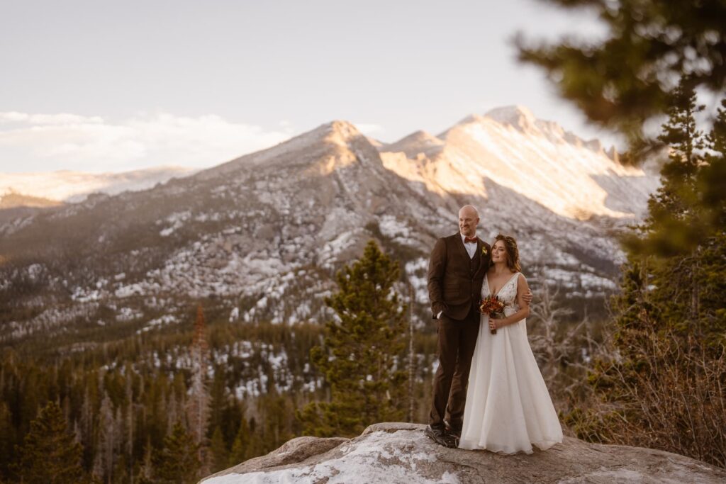 Couple looking off into the distance in the mountains on their wedding day