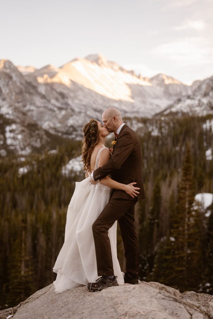 Bride and groom with snowy mountain backdrop in Estes Park