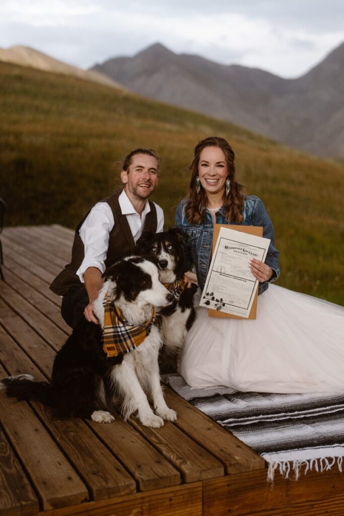 Couple with paw print stamped Colorado marriage license