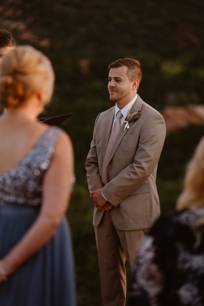 Groom looking toward bride on their wedding day in Colorado