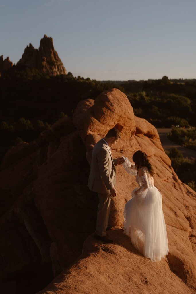 Couple walking on red rocks at Garden of the Gods