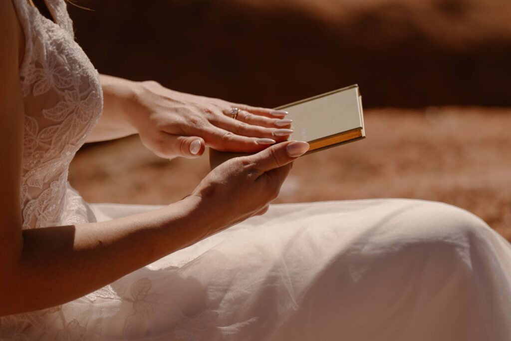 Bride's hand on her vow book during her Colorado wedding
