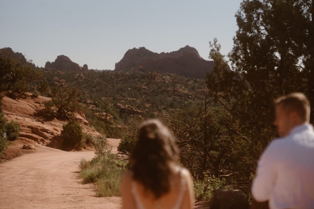 Bride and groom walking down a dirt road