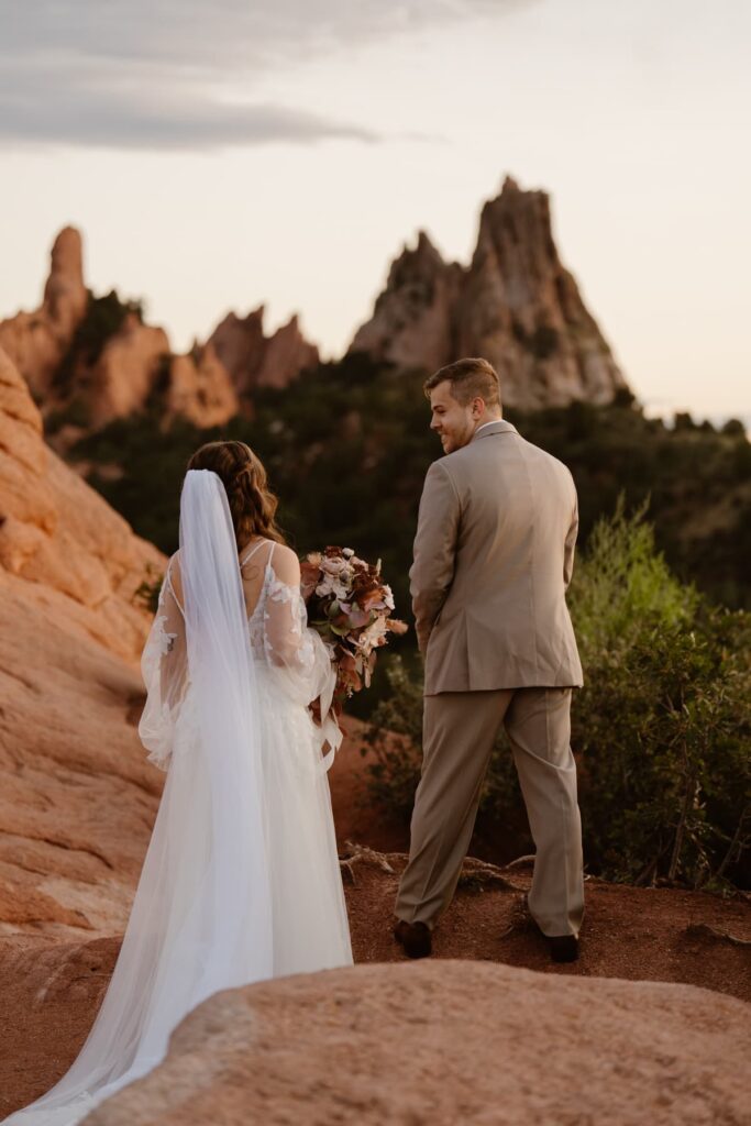 Groom turning to see his bride for a first look at High Point in Garden of the Gods