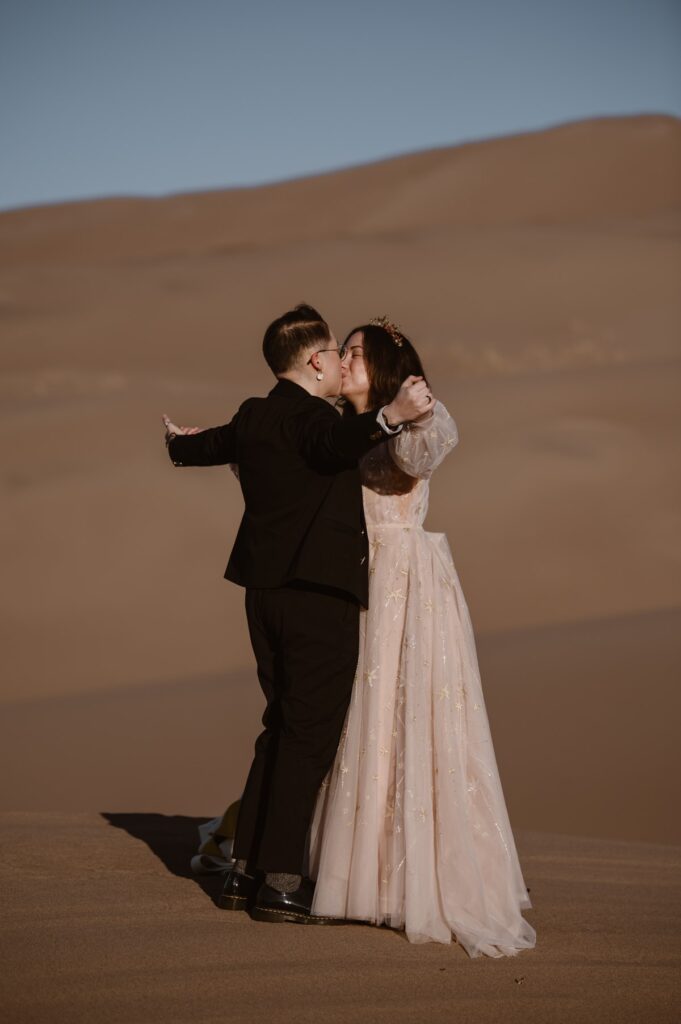 Couple kissing at Great Sand Dunes National Park after their elopement ceremony