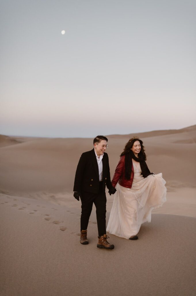 Couple walking onto the dunes during their Great Sand Dunes elopement