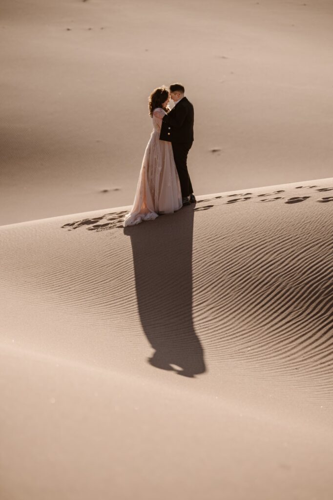 Couple kissing at Great Sand Dunes National Park after their elopement ceremony