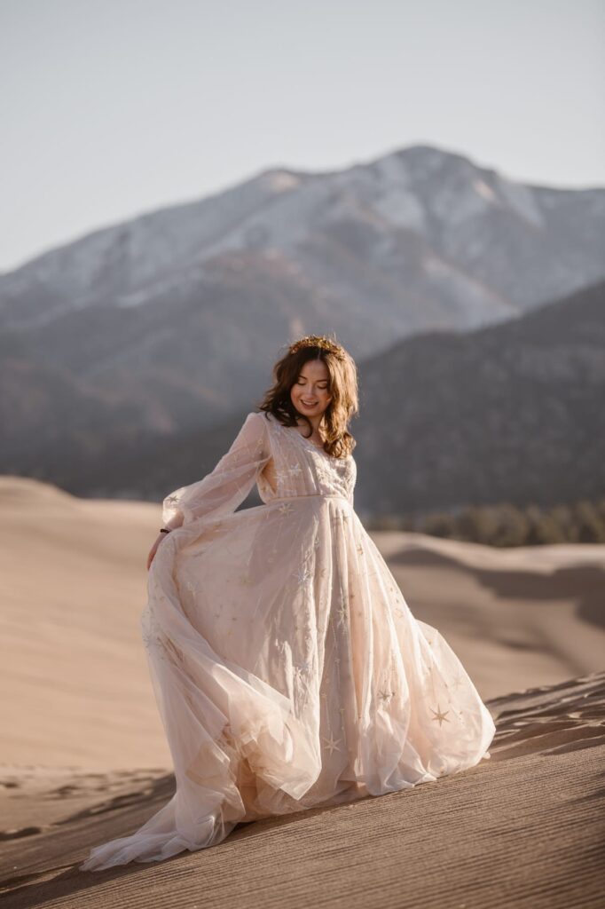 Bride spinning on top of sand dunes