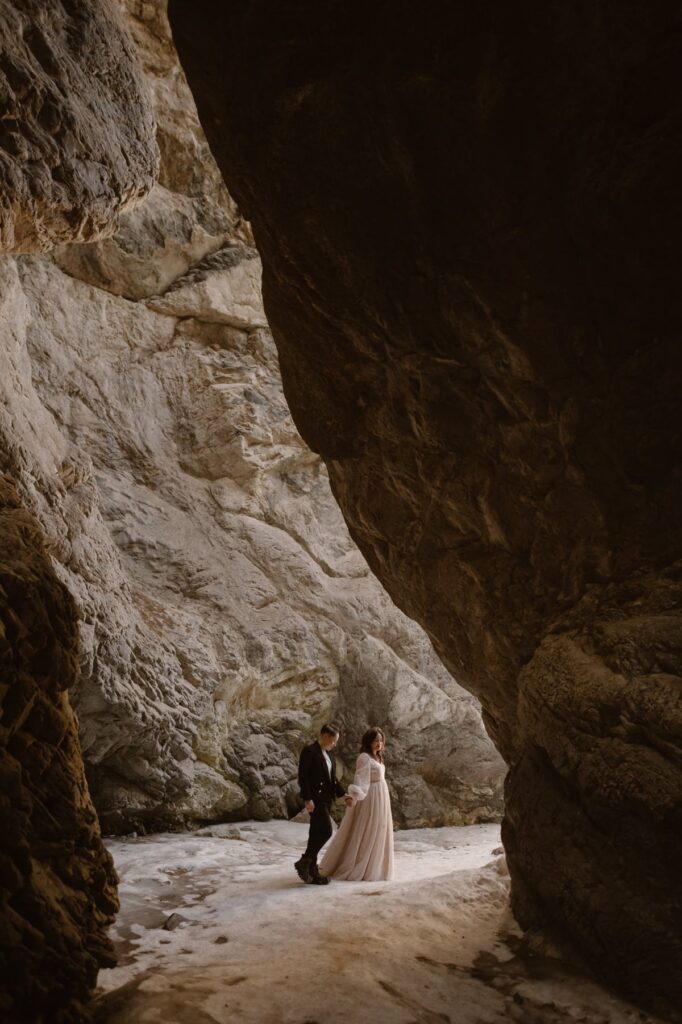 Couple walking on a frozen stream on their wedding day