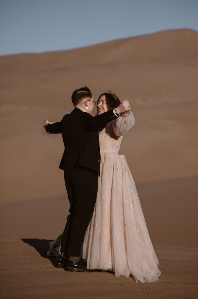 Couple sharing a first dance on the sand dunes during their elopement