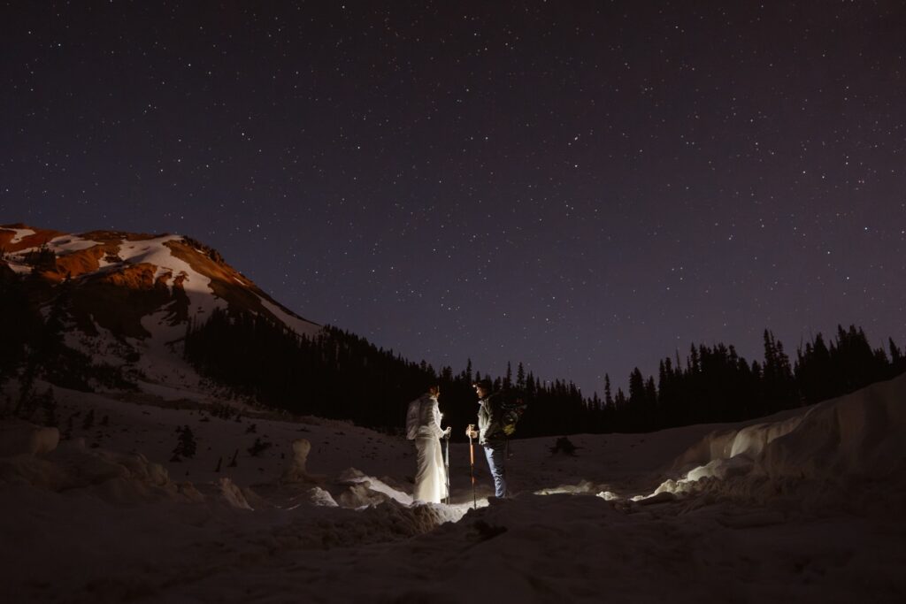 Couple hiking under the stars on their wedding day