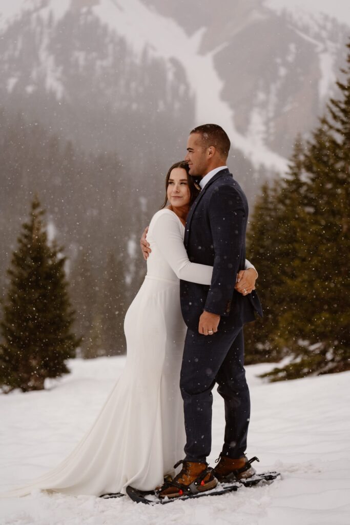 Couple hugging on their wedding day in the snowy mountains of Ouray, Colorado
