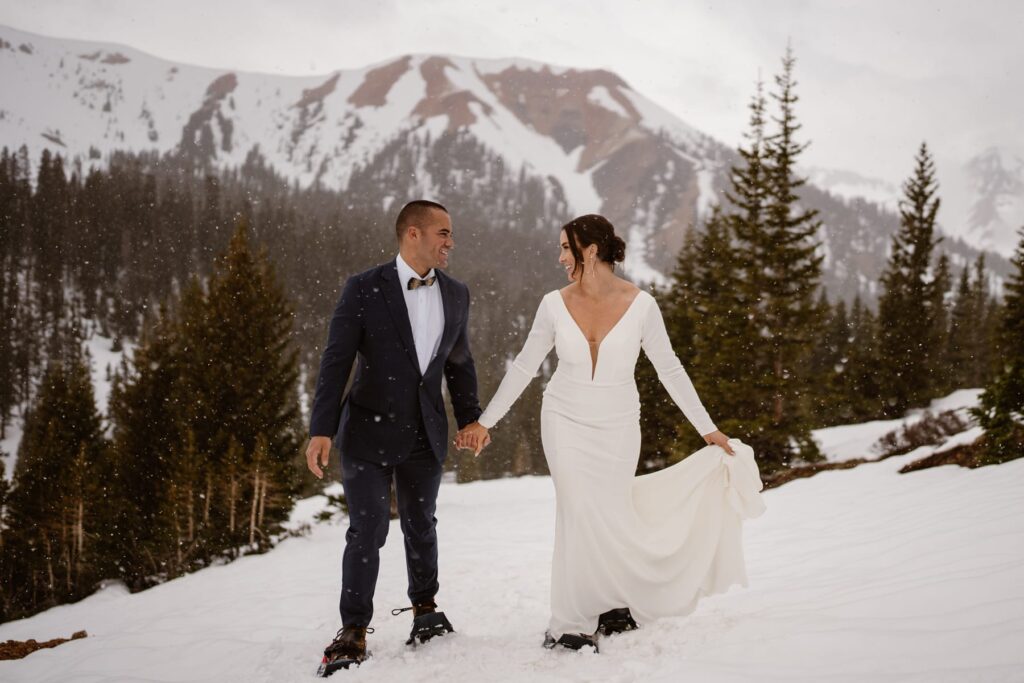 Red mountain view in the snow in Ouray, Colorado with bride and groom