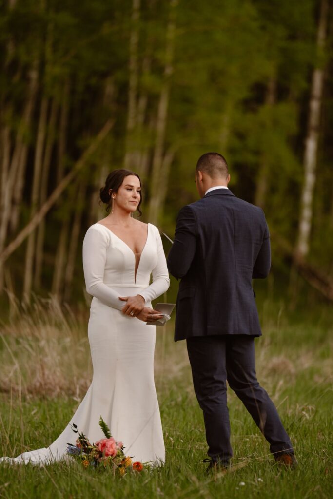 Couple sharing vows in a mountain meadow in Colorado
