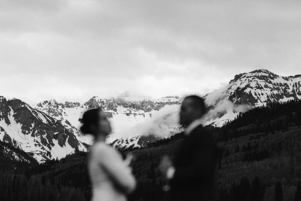 Bride and groom with moody mountains in Ouray, Colorado