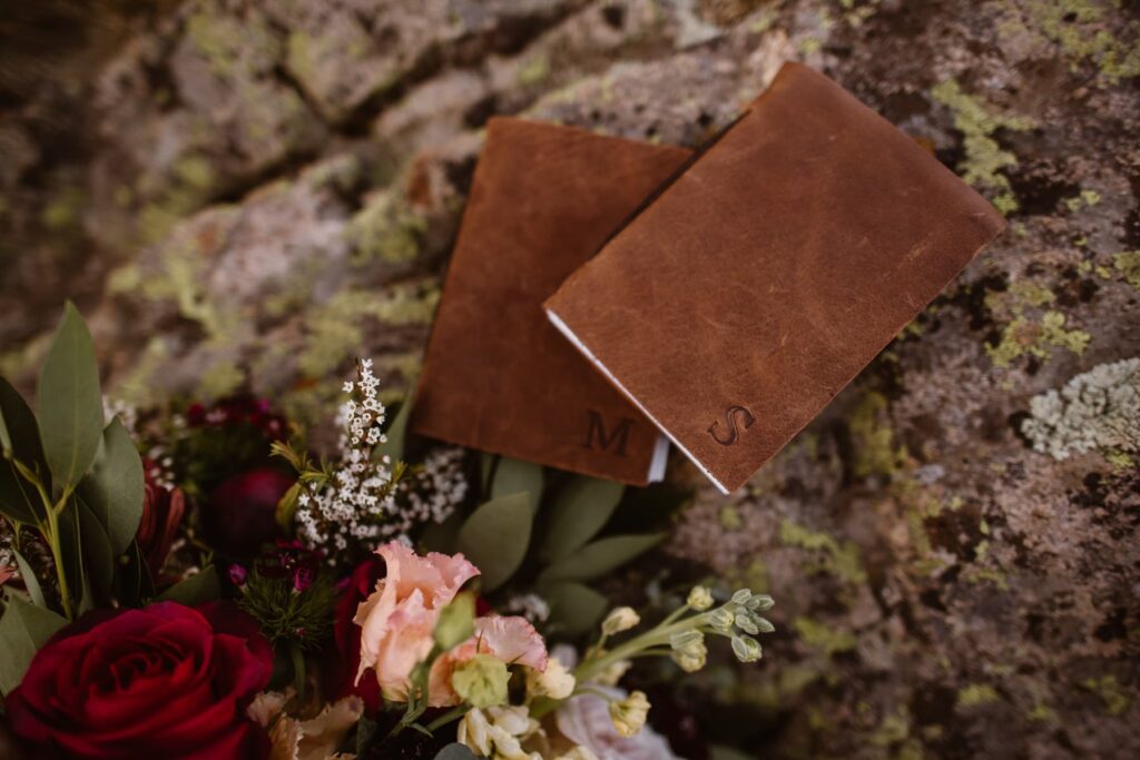 Leather vow books and flowers