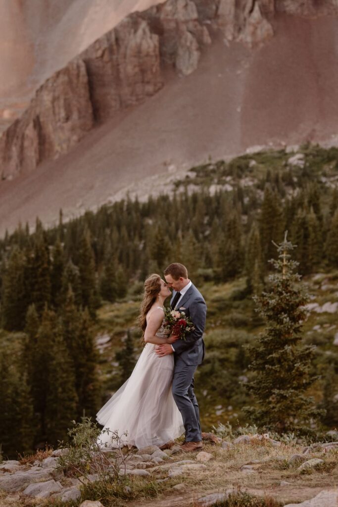 Couple sharing a kiss in the mountains of Telluride on their wedding day
