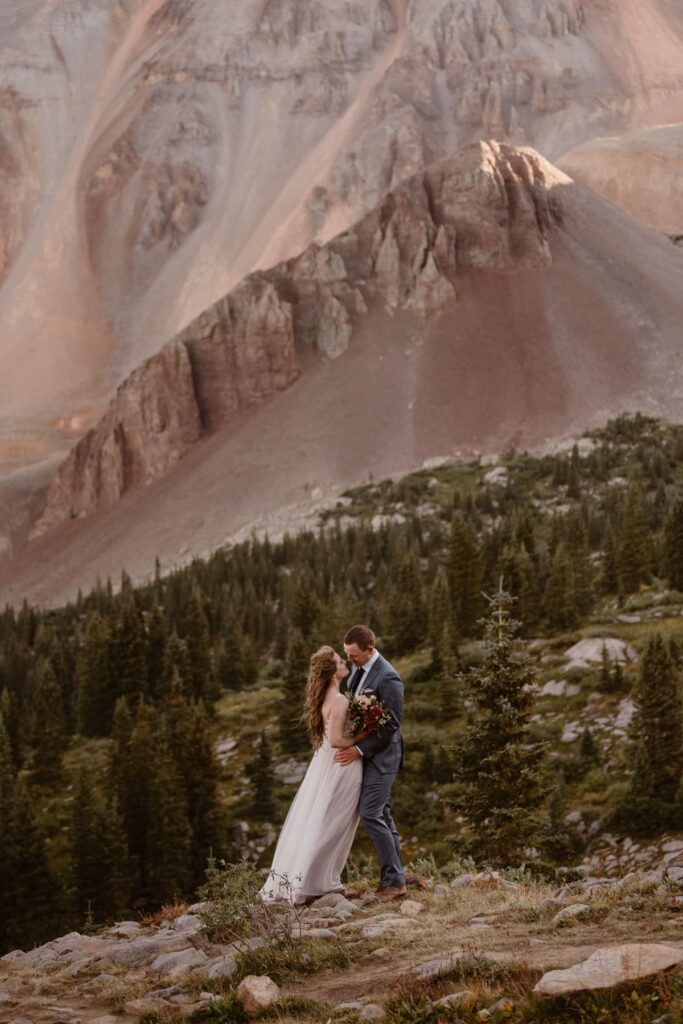 Couple on a rock overlooking mountains